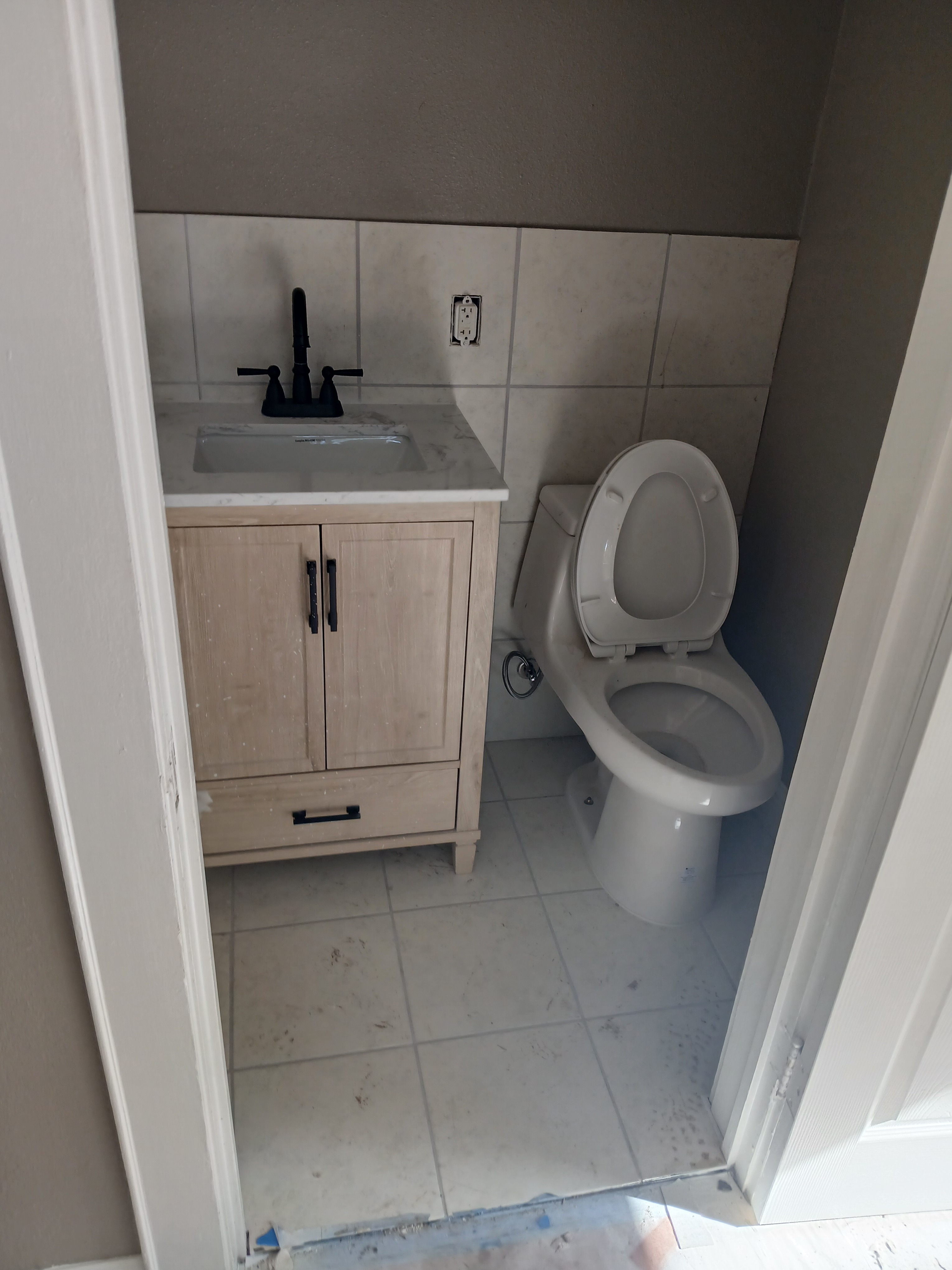 A white toilet sitting next to a sink in a bathroom